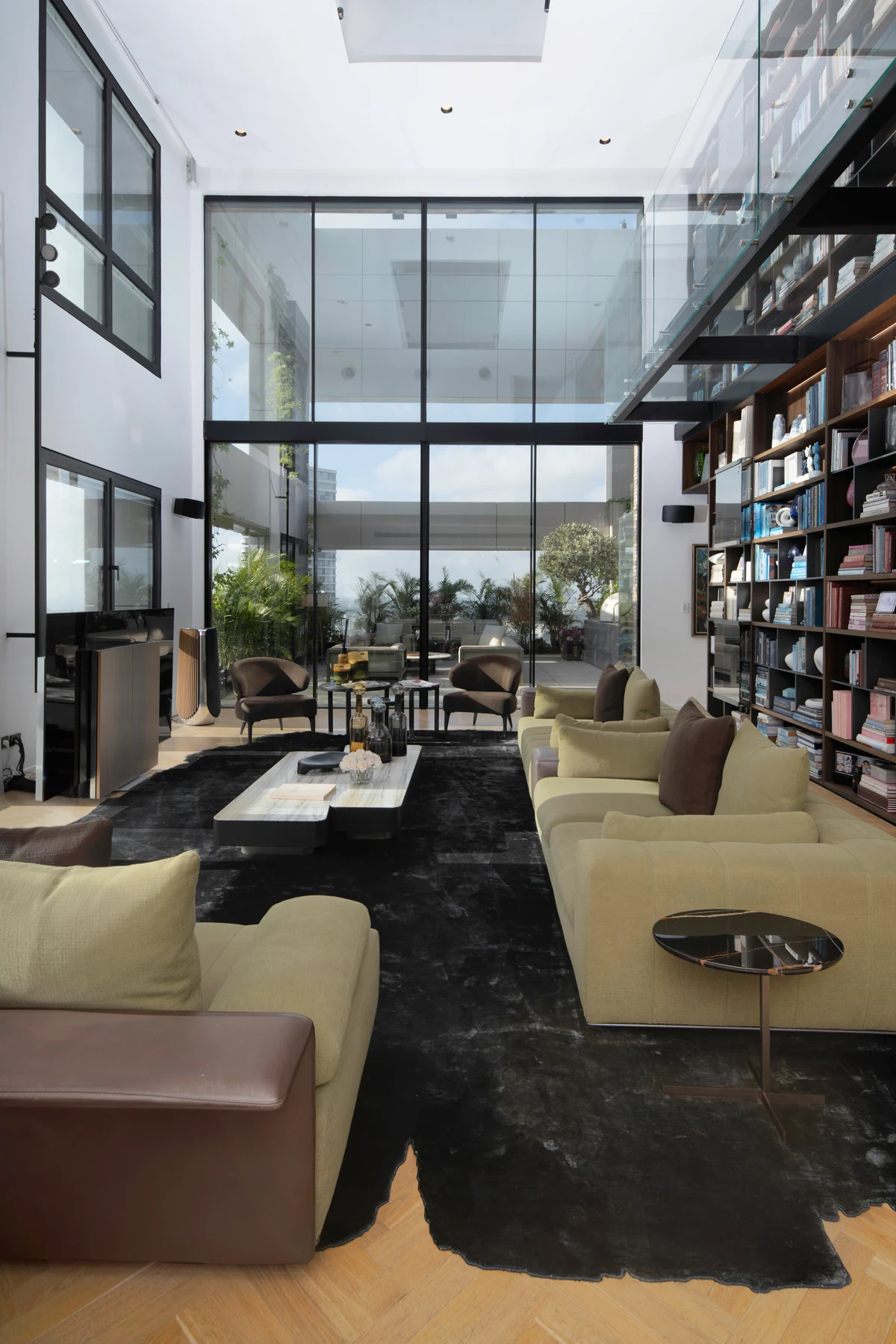 Double-height salon, expansive glazing and actual furnishings